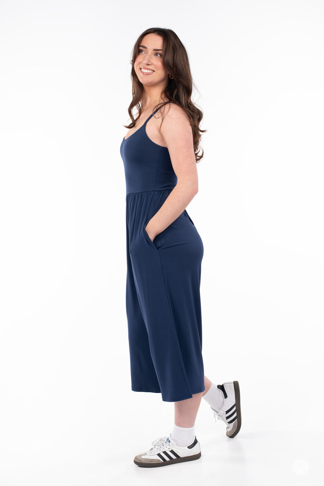 Woman smiling wearing navy blue SweetLegs Cropped Wide Leg Jumpsuit with pockets and thin straps side view