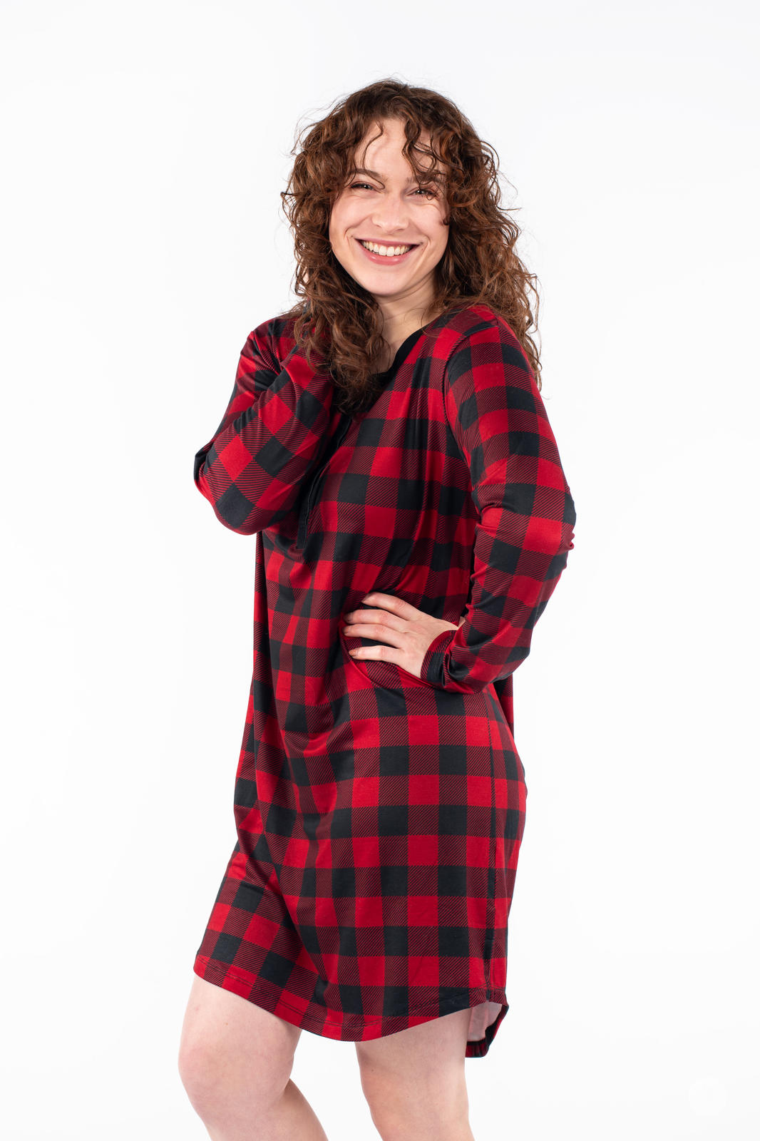 Woman smiling wearing SweetTops Henley Sleep Shirt in red and black buffalo plaid with relaxed fit side view