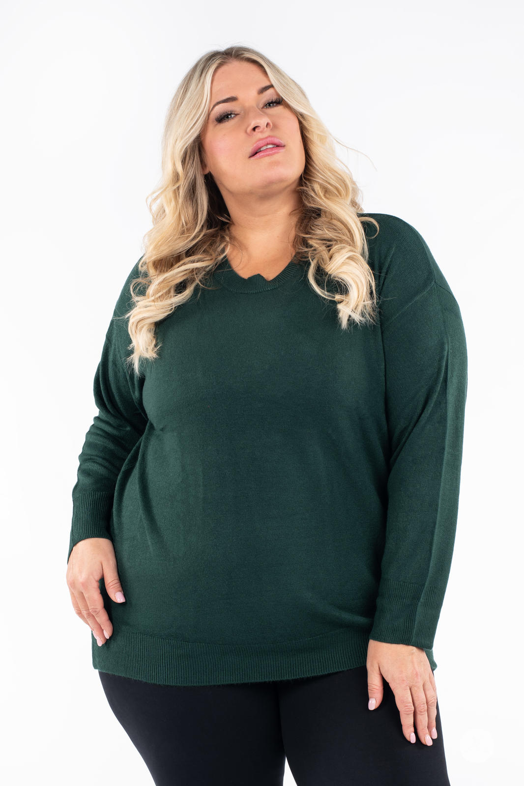 Plus size model wearing SweetTops Soft Knit Crew Neck Sweater in forest green with relaxed fit and long sleeves front view