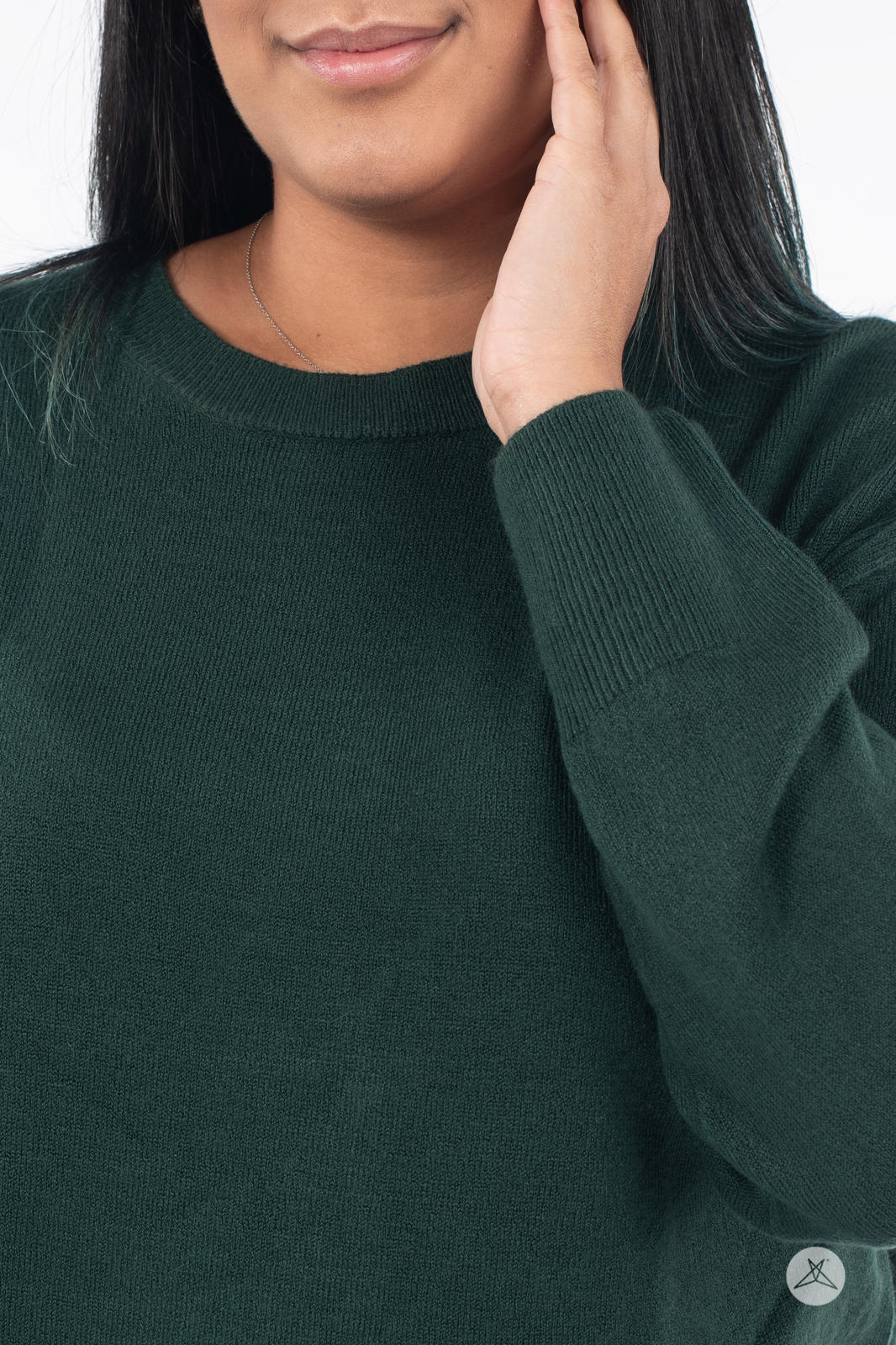 Close-up of model wearing SweetTops Soft Knit Crew Neck Sweater in forest green with ribbed cuffs and classic neckline
