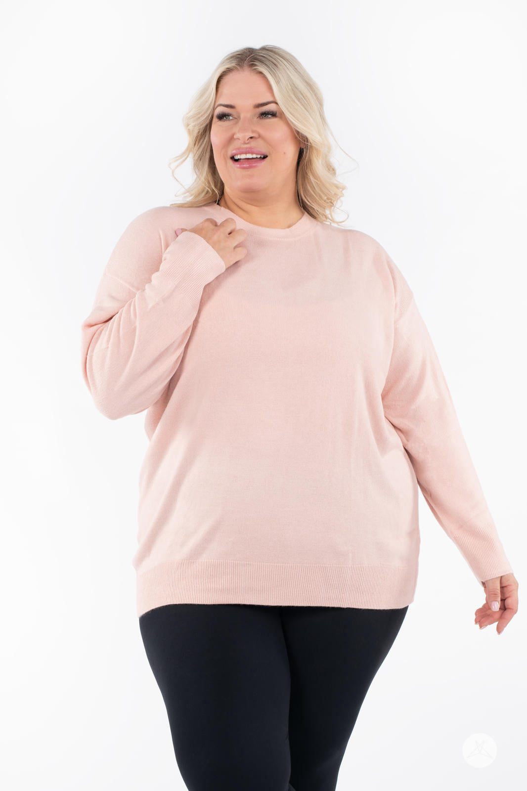 Plus size model wearing SweetTops Soft Knit Crew Neck Sweater in soft pink with relaxed fit and long sleeves front view