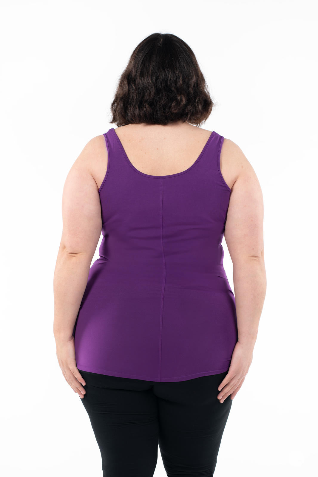 Plus size woman seen from back wearing deep purple Classic Layering Tank by SweetLegs Canada with black leggings on white background