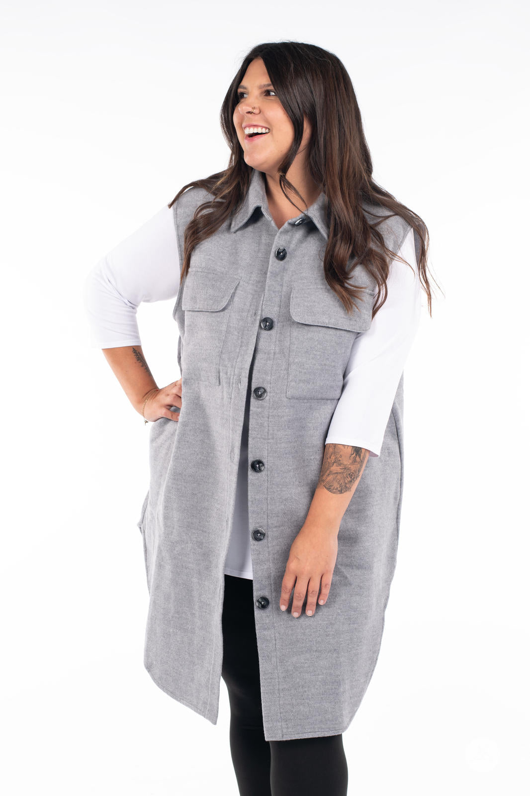 Smiling model wearing SweetLegs Canada Layering Shacket Vest in grey with button-up front and flap pockets