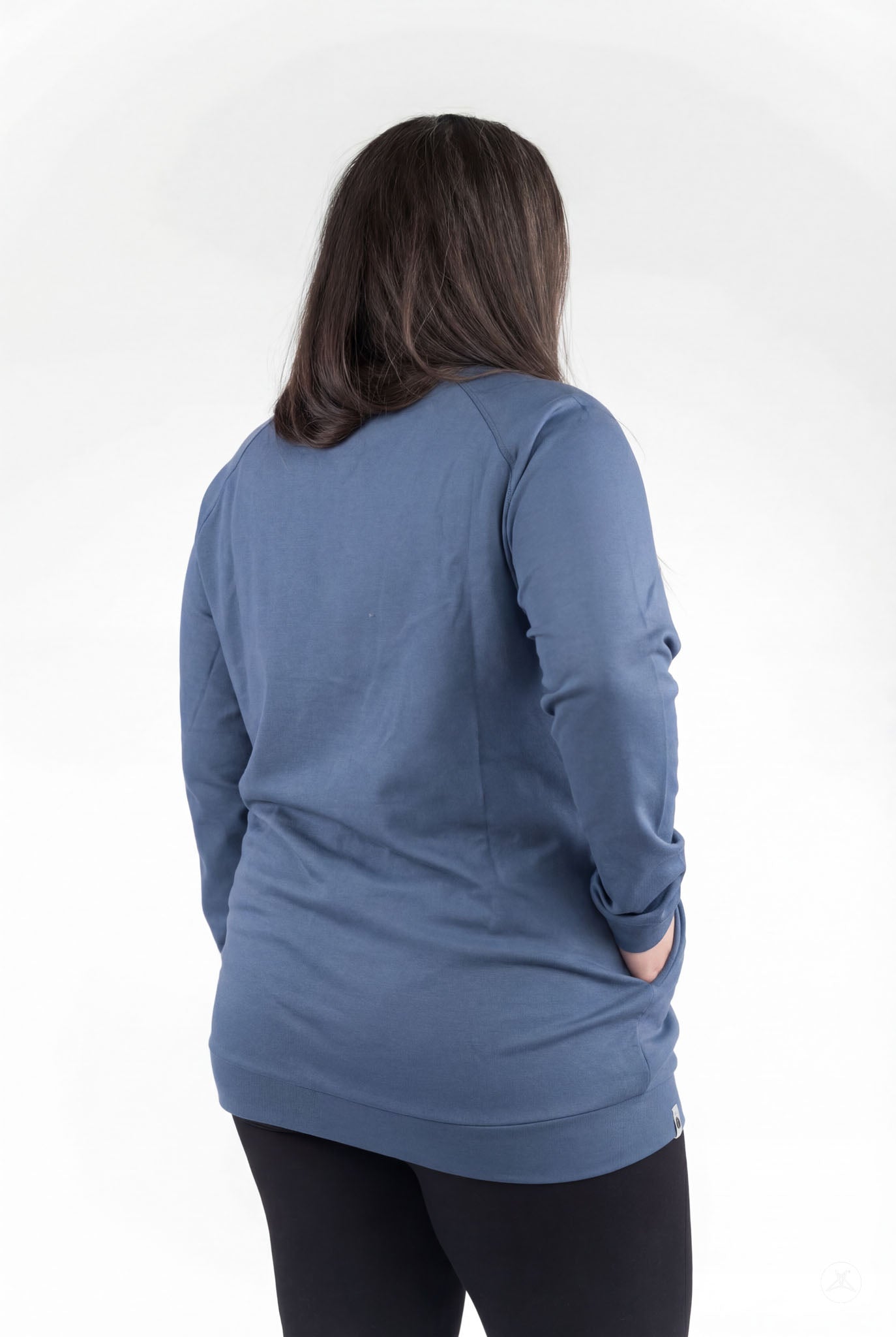 Back view of a person wearing a blue Basic Raglan Pullover (Copy) by SweetLegs Canada with hands in pockets
