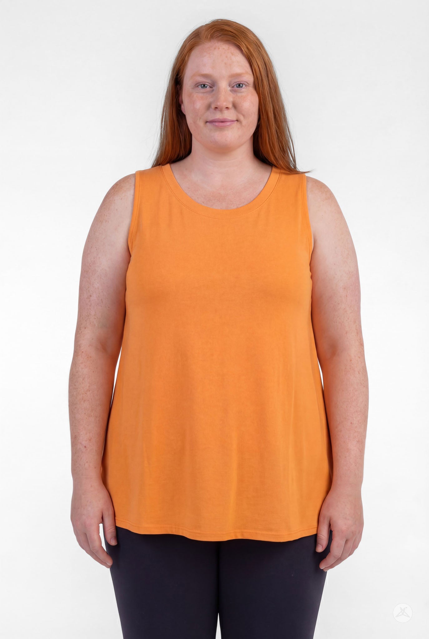 Woman wearing orange sleeveless High Neck Tank by sweettops standing against white background
