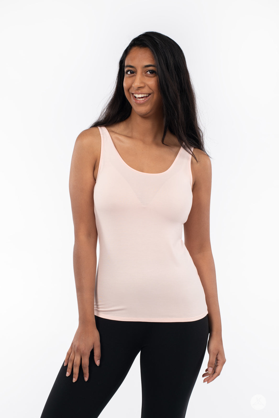 Smiling woman modeling SweetLegs Canada Classic Tank in Latte color paired with black leggings on white background
