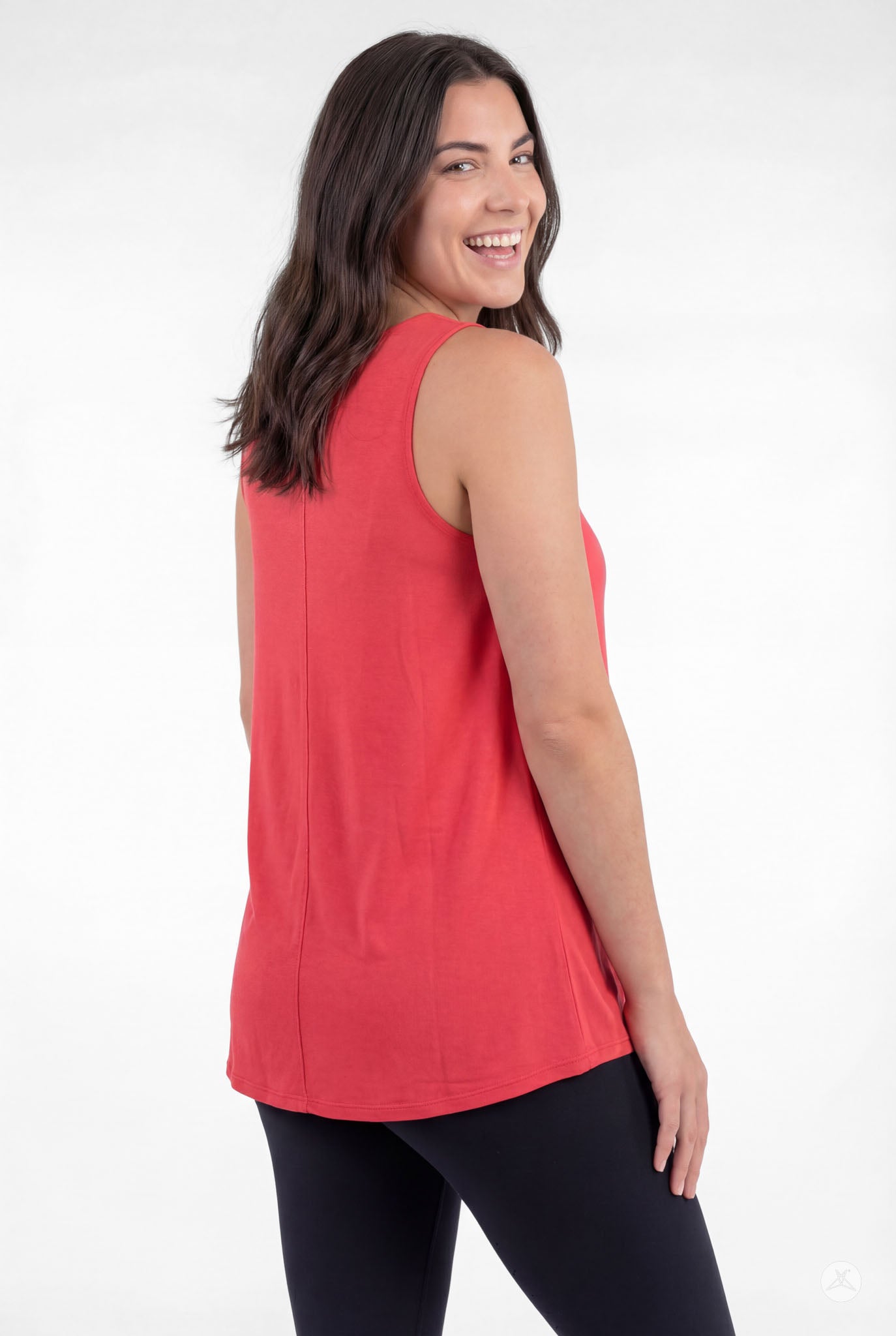 Smiling woman wearing sleeveless red High Neck Tank by sweettops with black leggings shown from back