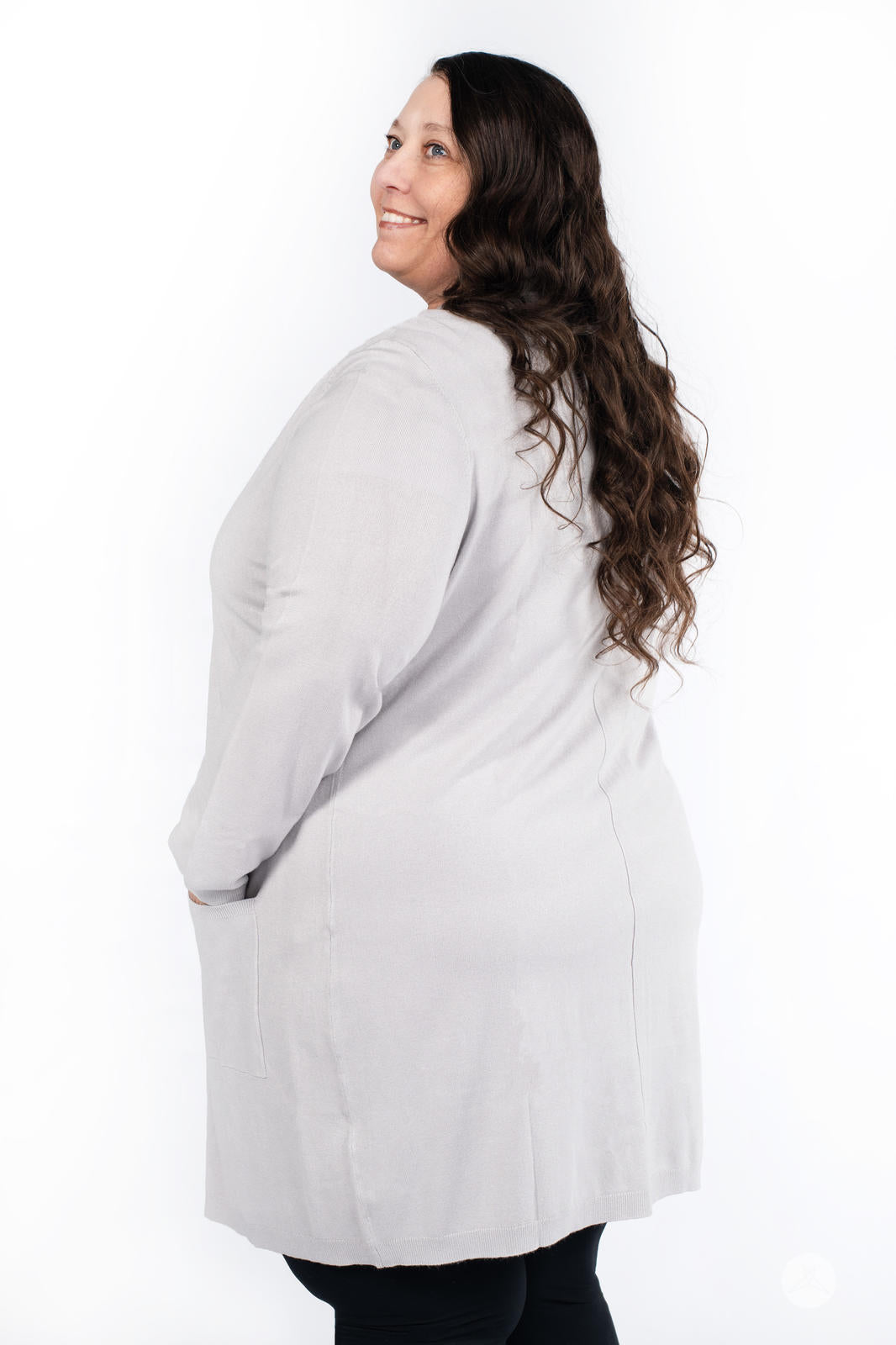 Plus-size model wearing SweetLegs Canada Spring Cardigan in light grey with patch pockets back view