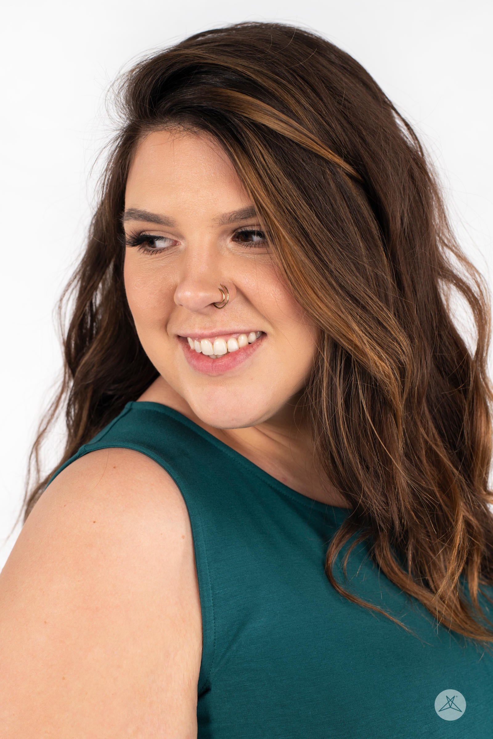 Close-up of smiling model wearing SweetTops The Weekender Dress in deep green showing sleeveless design and hair details
