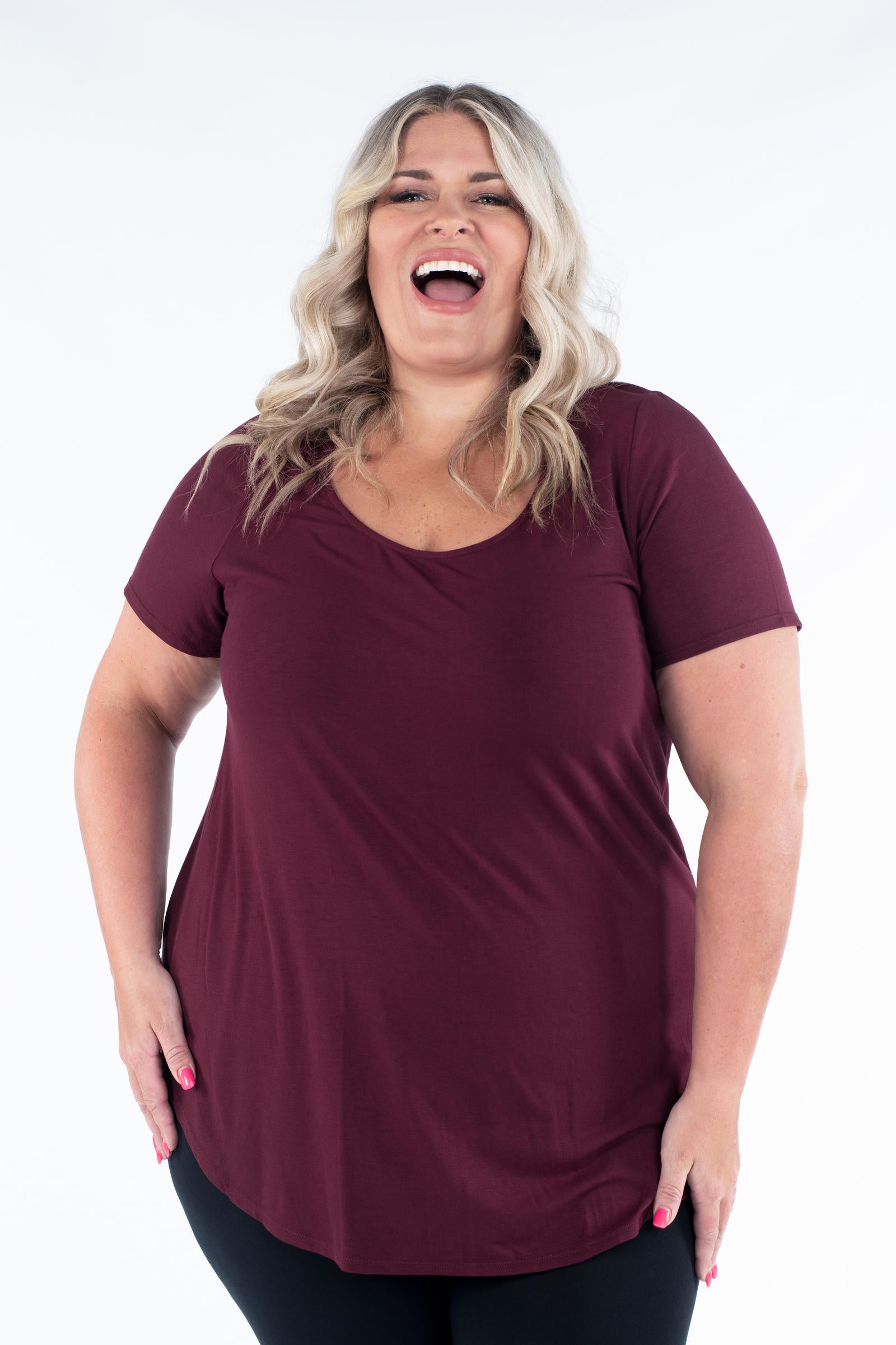 Plus size model laughing in maroon Classic Tee by SweetLegs Canada with scoop neckline and relaxed fit front view