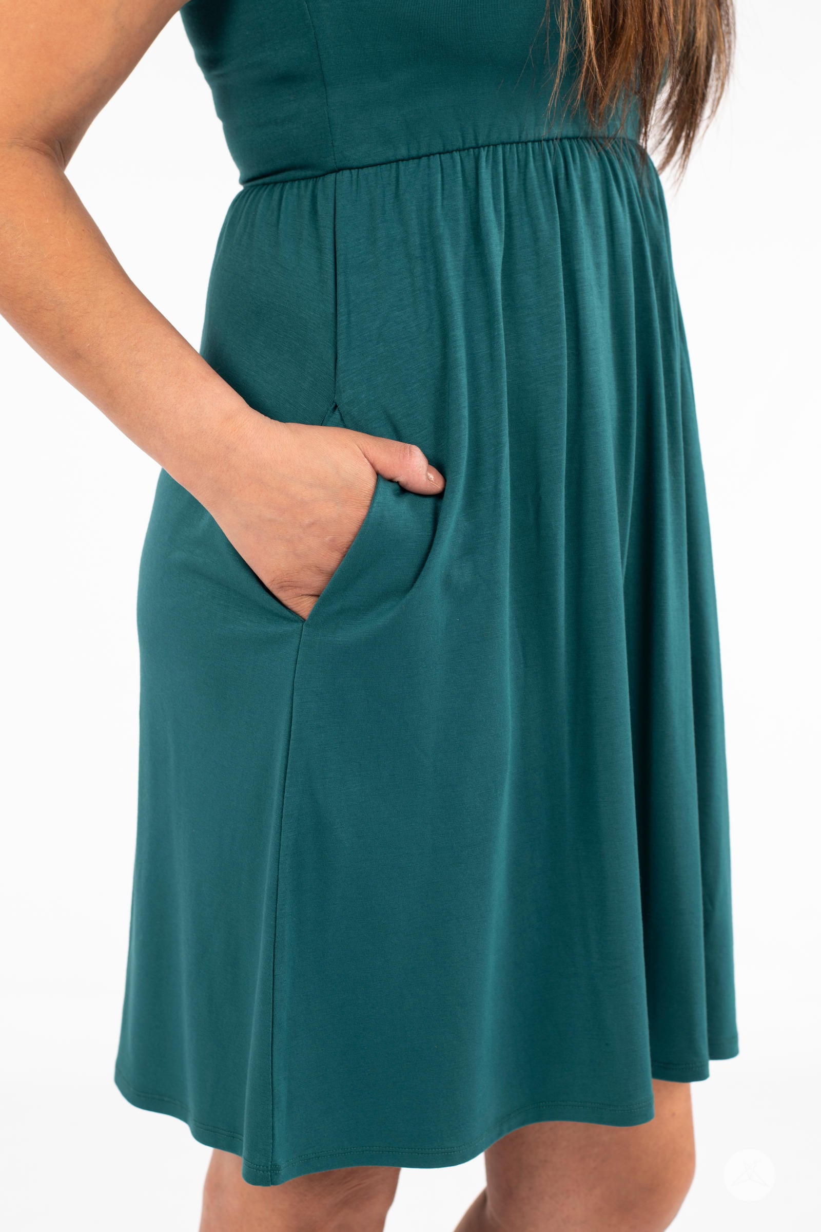 Close-up of hand in pocket on teal SweetTops The Weekender Dress showing soft gathered fabric and relaxed fit