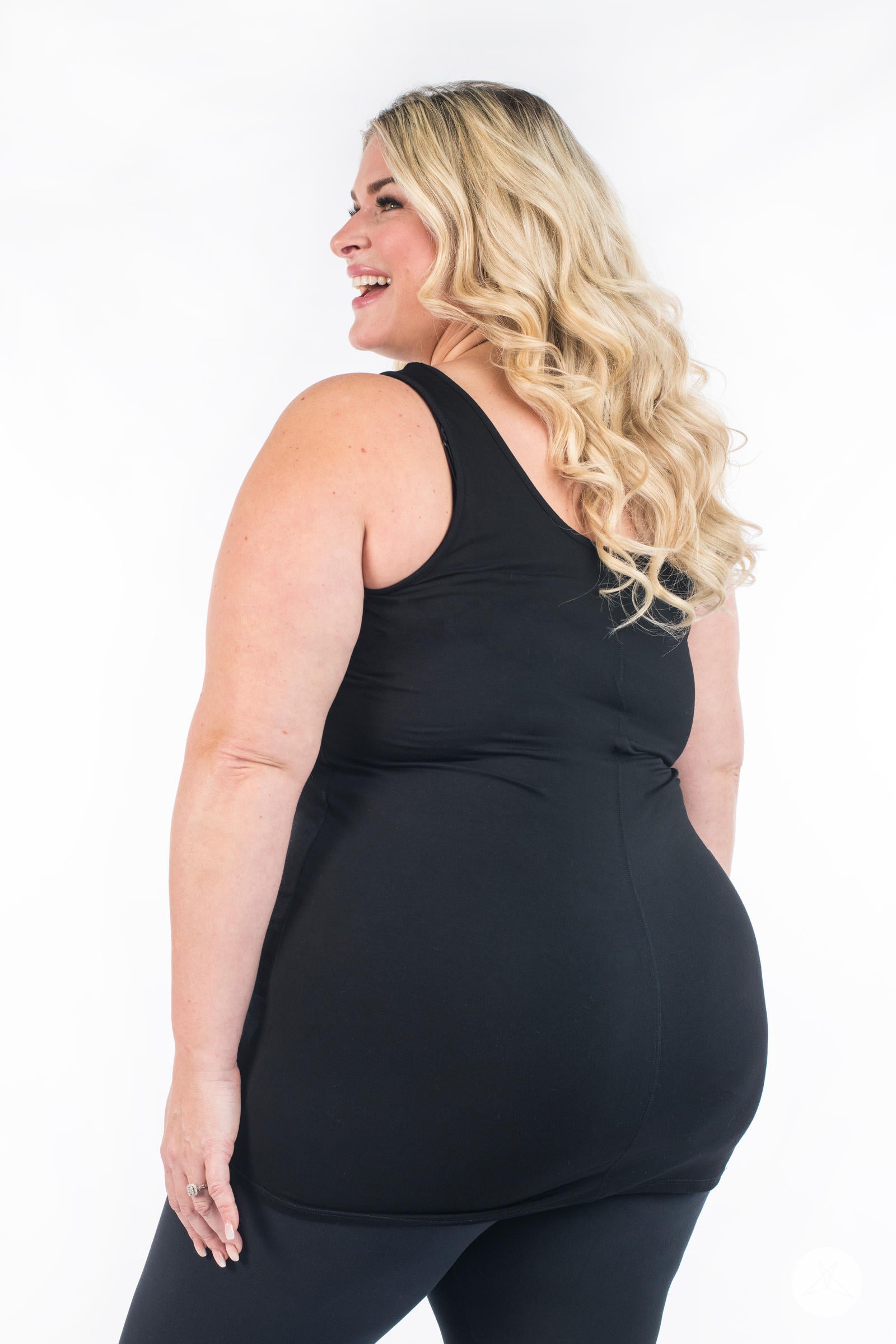 Plus-size woman smiling wearing SweetLegs Canada Classic Layering Tank in black showing back view on white background