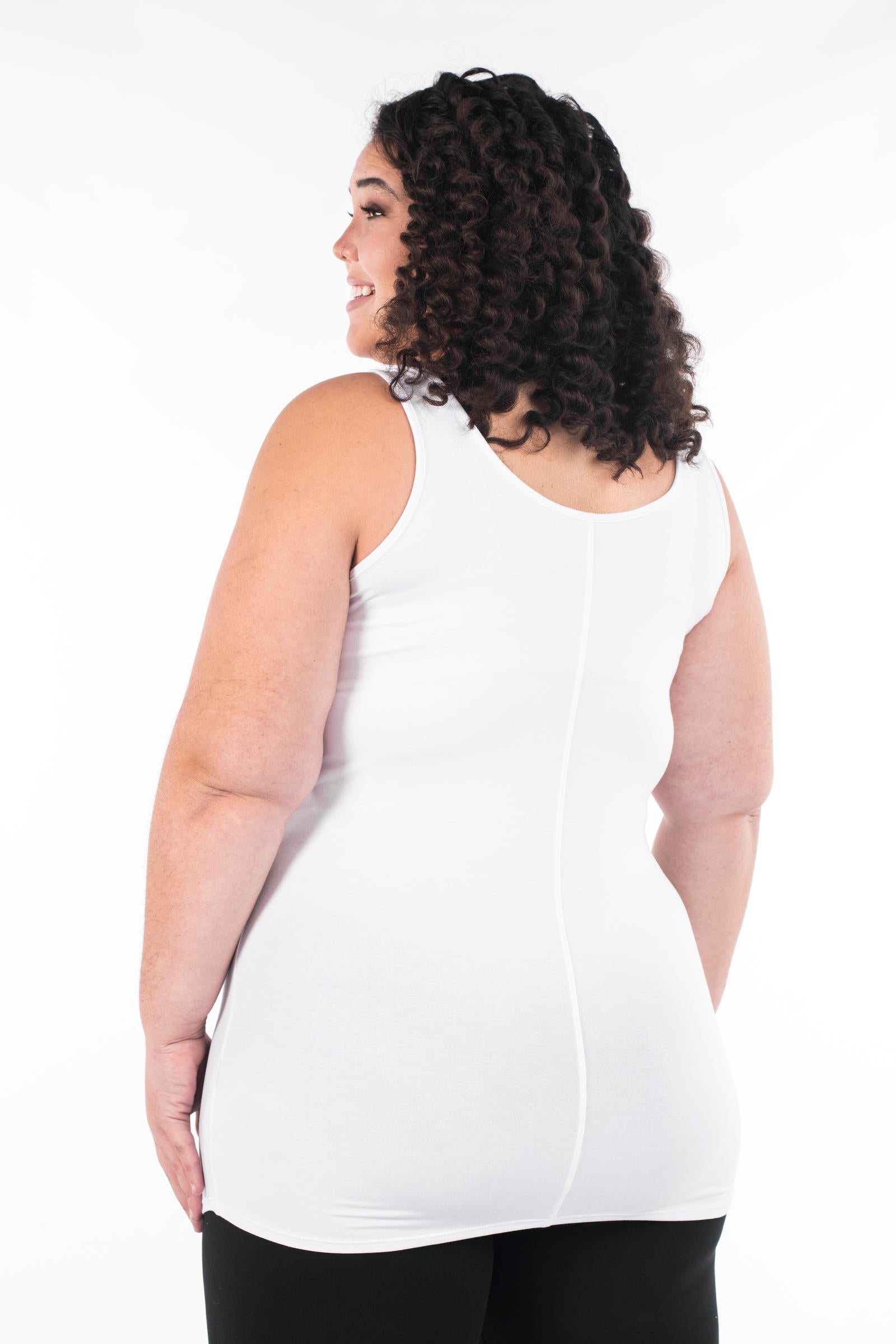 Plus-size model smiling and showing back of SweetLegs Canada Classic Layering Tank in white with soft, smooth fit