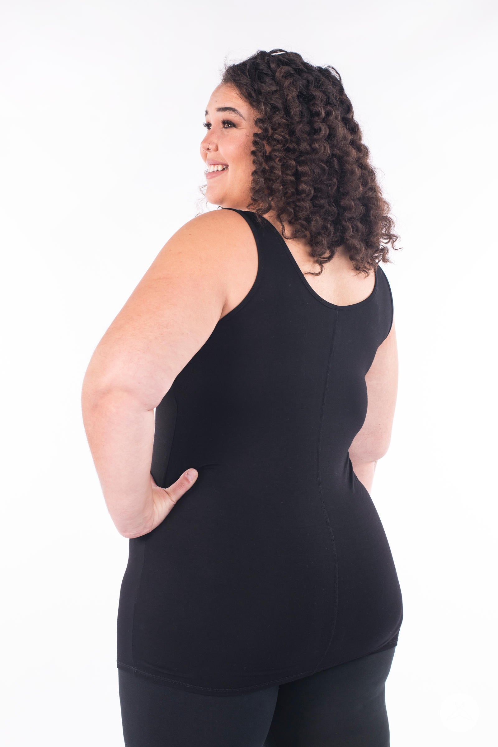 Plus-size model smiling and posing in black SweetLegs Canada Classic Layering Tank with a smooth back fit on white background