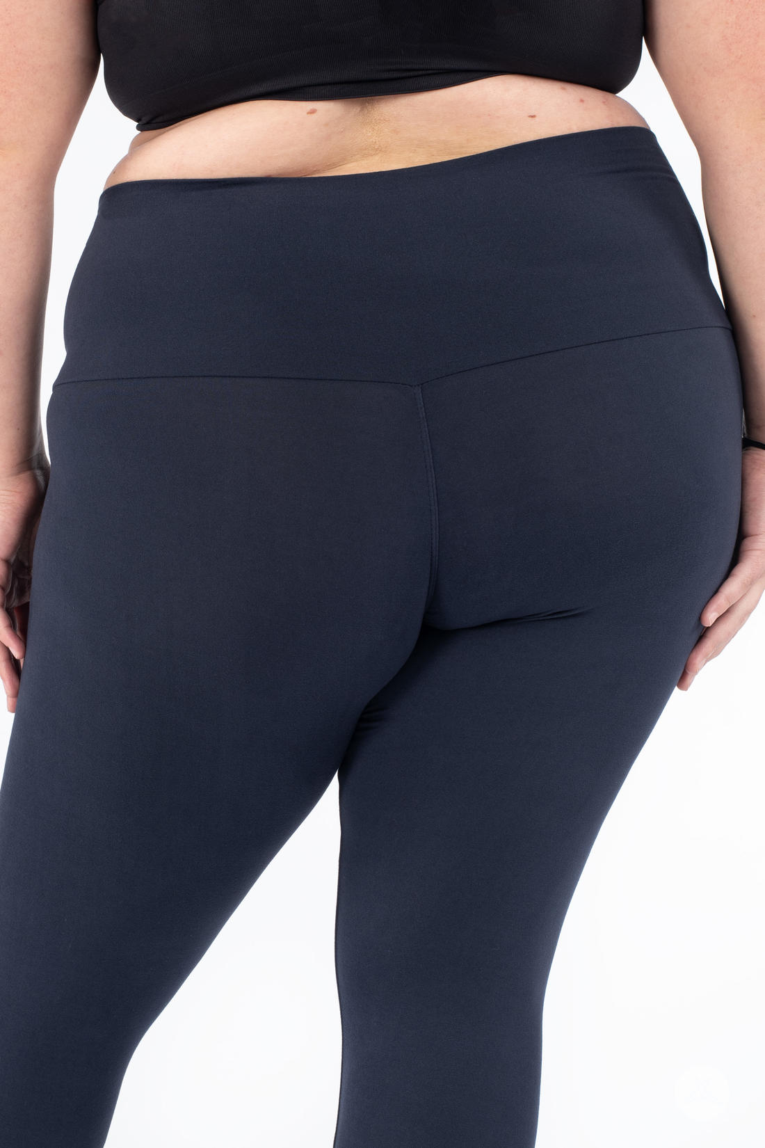 Plus-size model wearing SweetLegs Navy Wide Waistband Leggings with a wide mid-rise waistband and smooth navy fabric fit