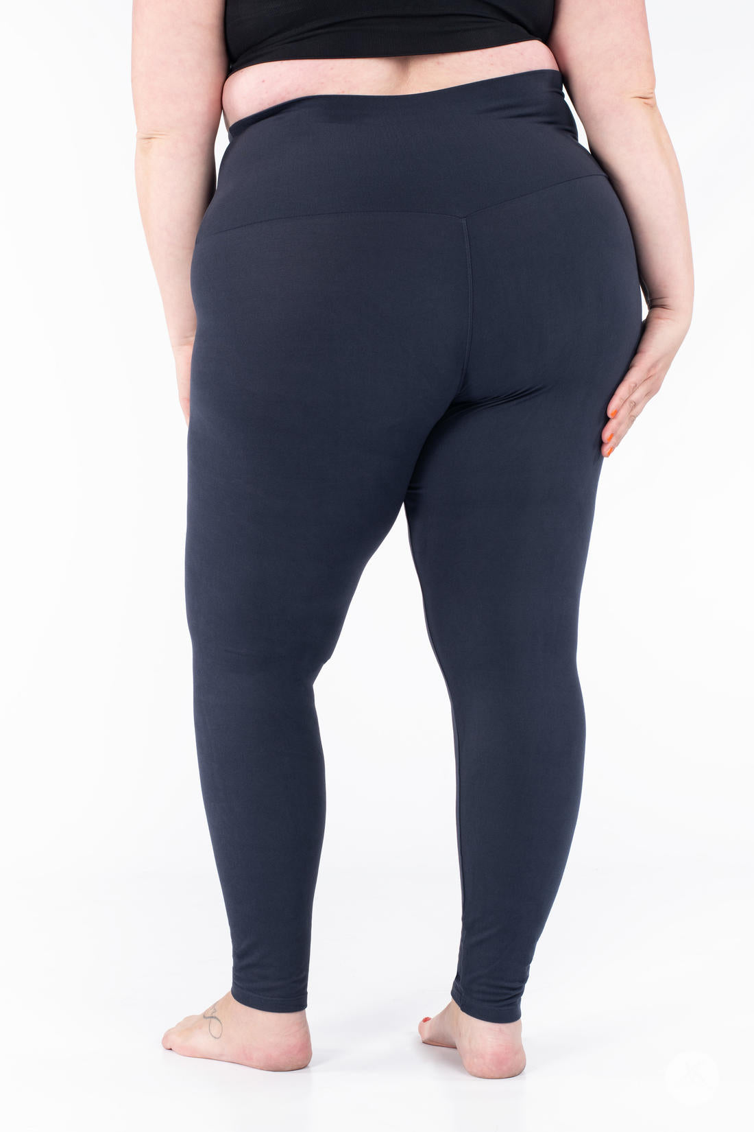 Plus-size model wearing SweetLegs Navy Wide Waistband Leggings showing a smooth back fit with mid-rise wide yoga waistband