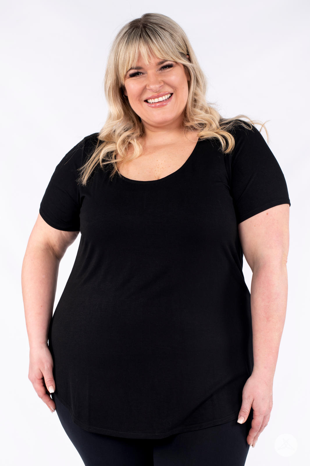 Smiling plus size woman wearing black Classic Tee by SweetLegs Canada with scoop neck and relaxed fit front view
