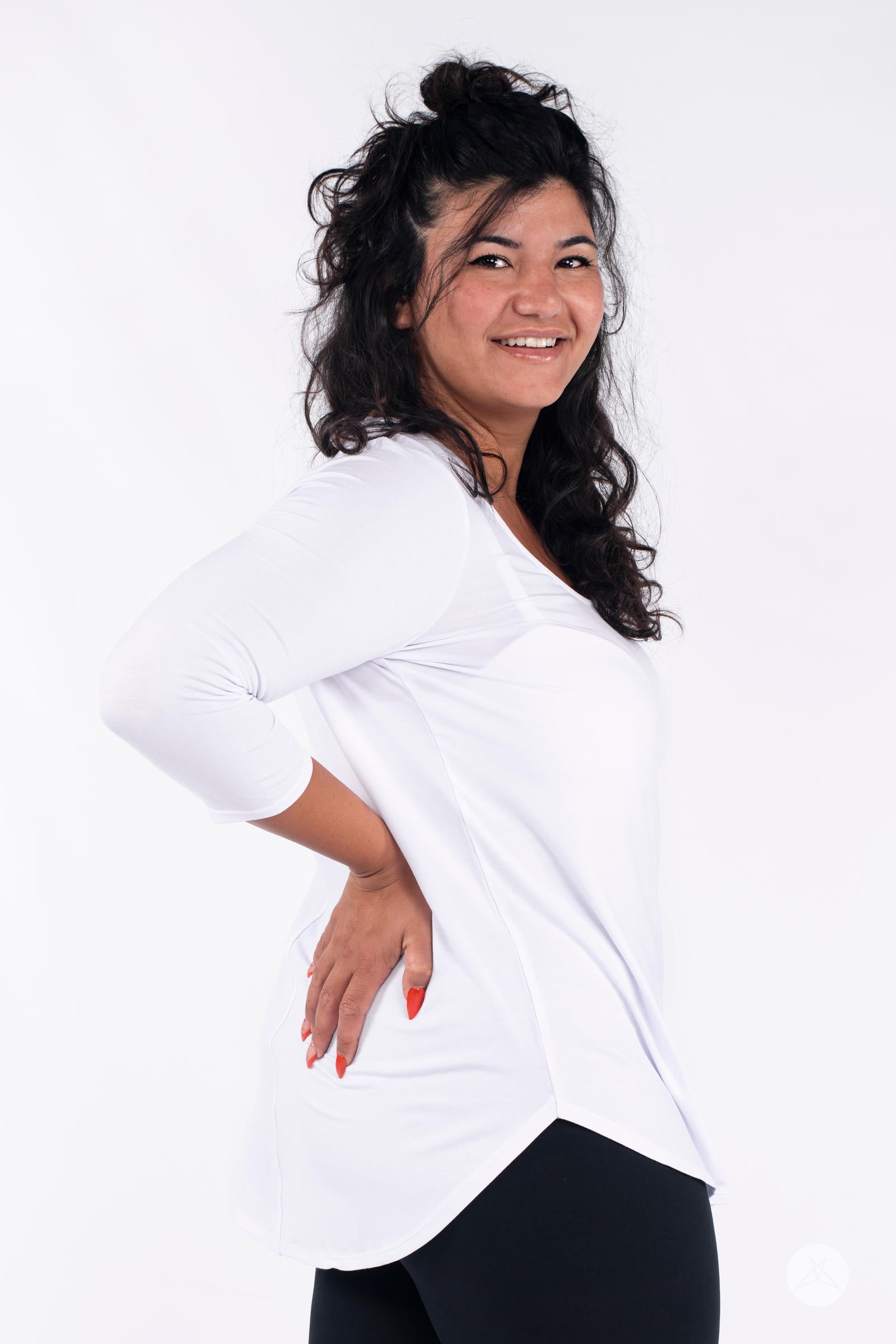Classic 3/4 Tee by SweetLegs Canada in white with high-low hem and fitted sleeves on smiling plus-size model side view
