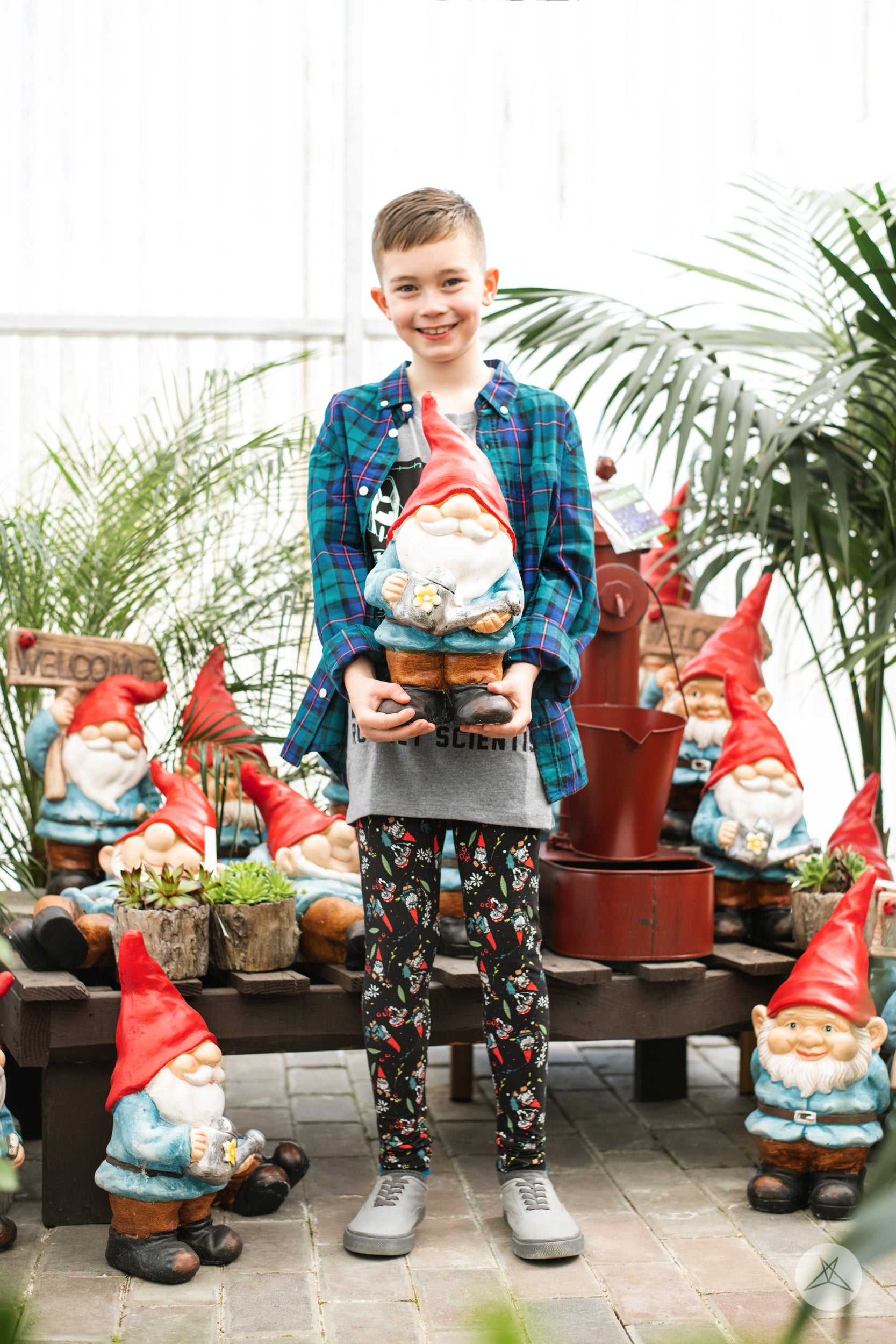 Garden Party Kids leggings by SweetLegs with garden gnomes, mushrooms, and floral details on black for a whimsical look