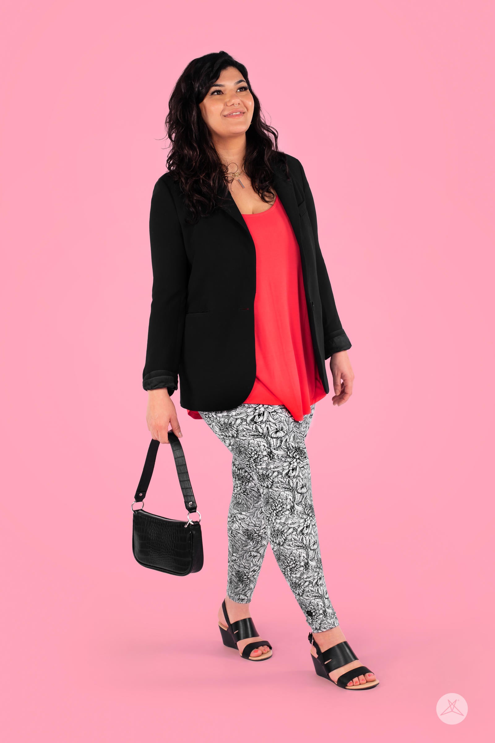 Woman wearing SweetLegs Sketchbook leggings with large-scale black and white floral sketch pattern against pink background