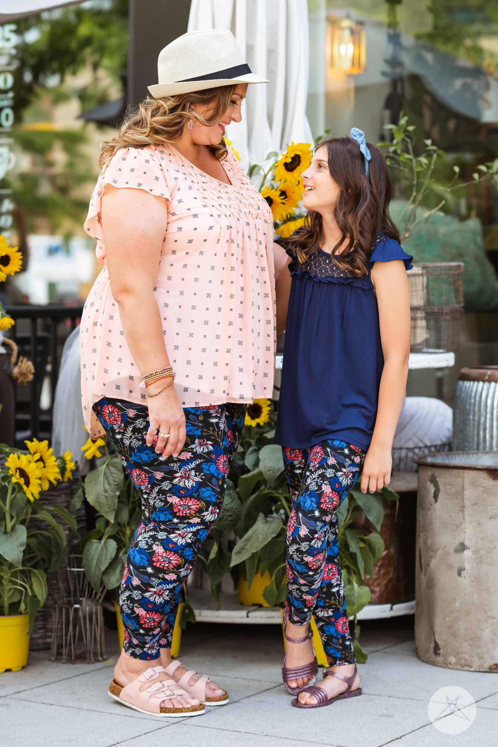 Mother and daughter wearing SweetLegs Lovely Day Kids floral leggings with coral-red and persian-blue garden print
