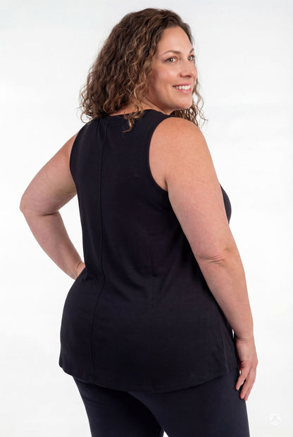 Plus size woman wearing black High Neck Tank by sweettops shown from back smiling on white background