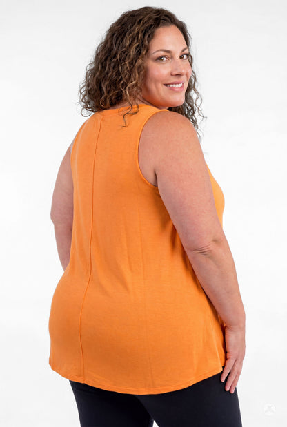 Plus size woman smiling over shoulder wearing sweettops High Neck Tank in vibrant orange and black pants