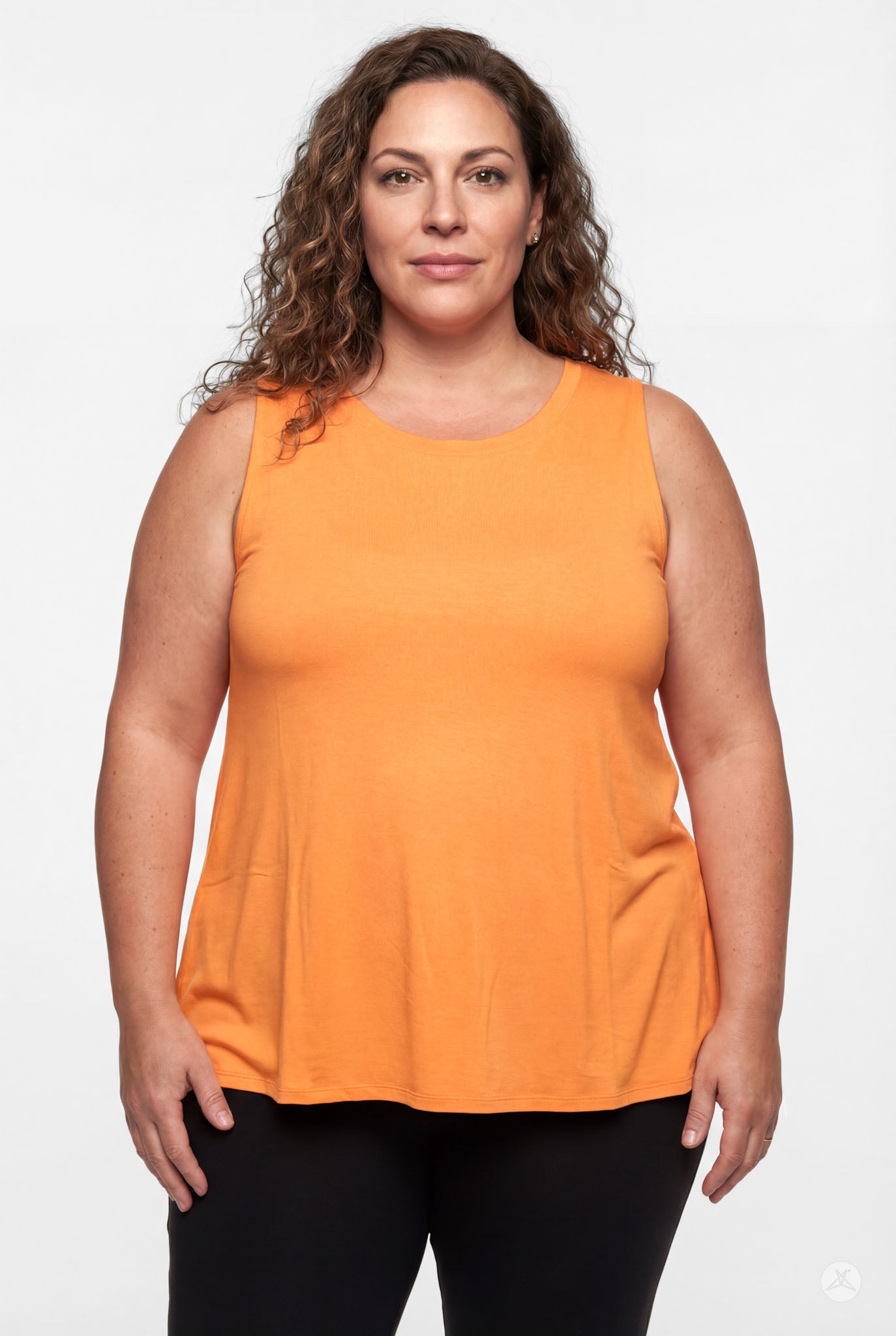 Plus size woman wearing orange sleeveless High Neck Tank by sweettops standing confidently against white background