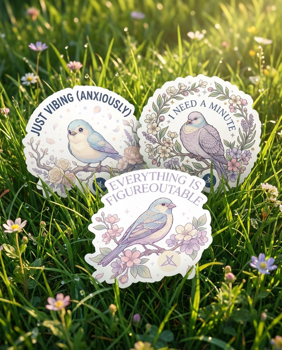 Three bird stickers with floral designs and phrases from the I Need A Minute Sticker Pack by SweetLegs on grass background