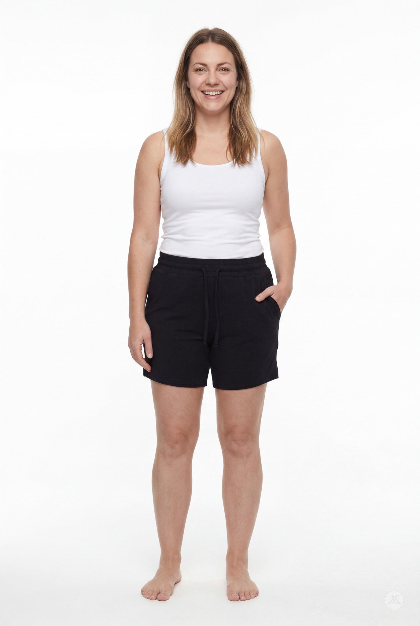 Smiling woman wearing black Lounge Shorts by SweetLegs with pockets and drawstring waist on plain white background