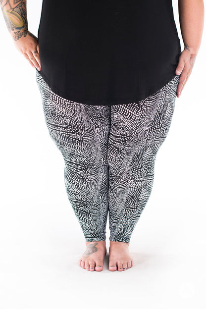 Front view of SweetLegs Charmed leggings showcasing black and white abstract snakeskin dots on plus size legs
