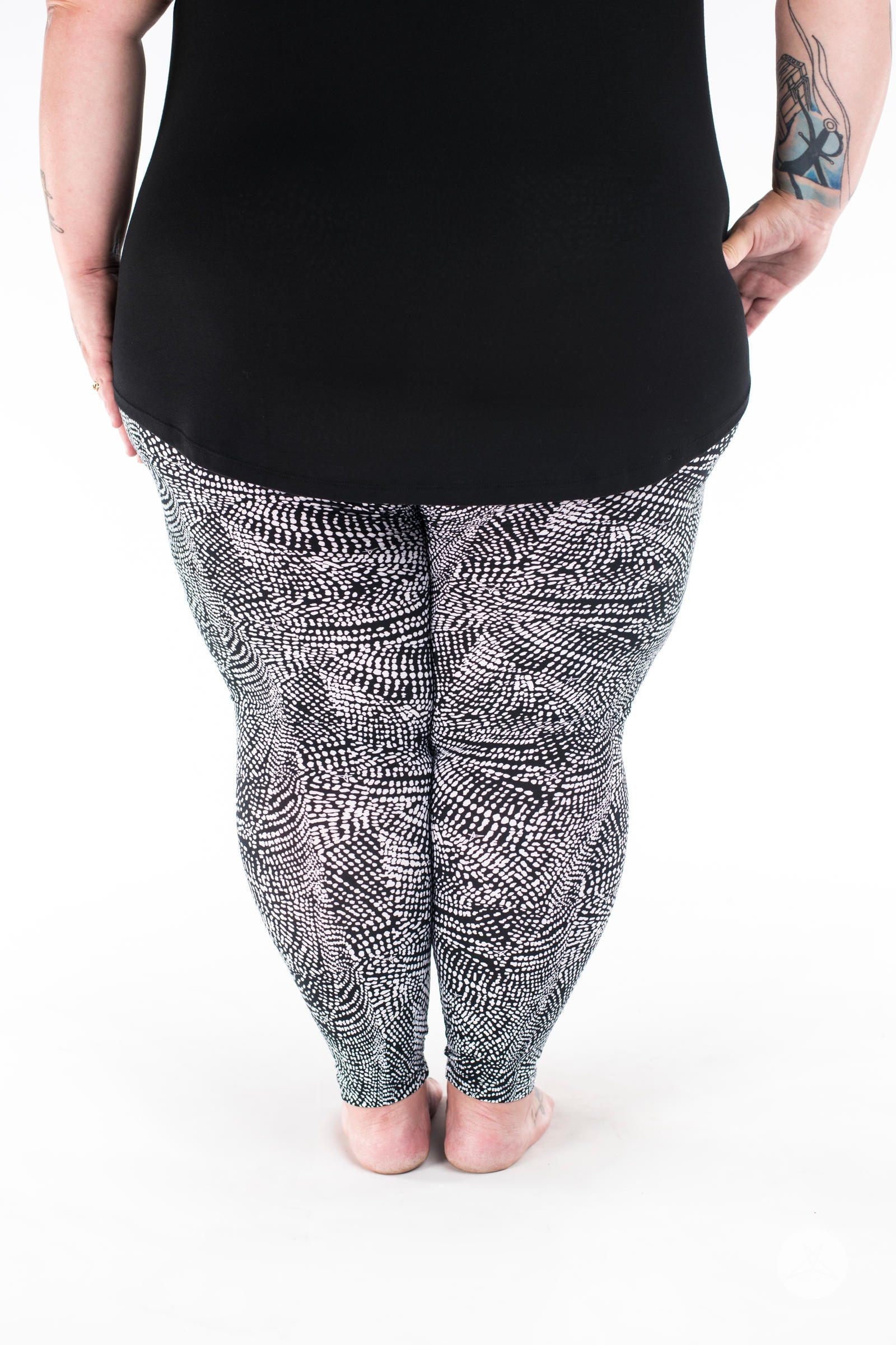 Rear view of SweetLegs Charmed leggings with black and white deconstructed snakeskin pattern on plus size legs