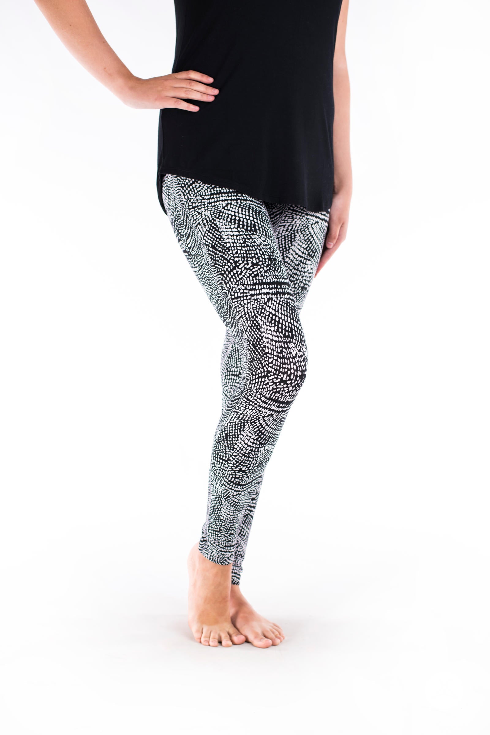 Side view of SweetLegs Charmed leggings with a black and white geometric deconstructed snakeskin pattern on model legs