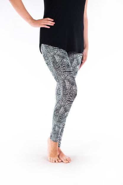 Side view of SweetLegs Charmed leggings with a black and white geometric deconstructed snakeskin pattern on model legs