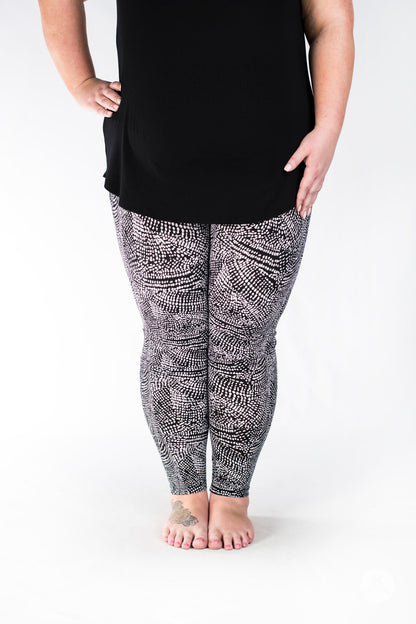 Plus size legs wearing SweetLegs Charmed leggings with a black and white abstract deconstructed snakeskin print