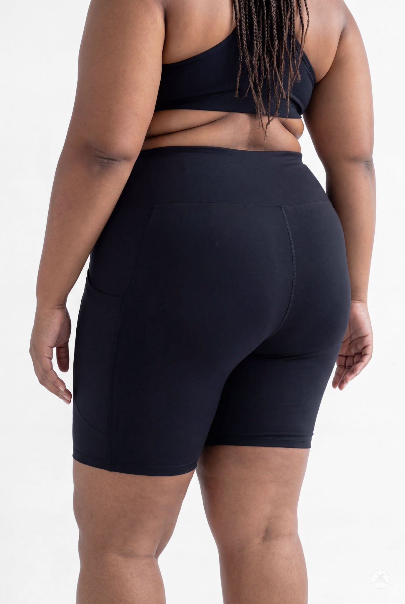 Plus size model showcasing SweetLegs Black High-Waisted Pocket Biker Shorts with back and side pocket view