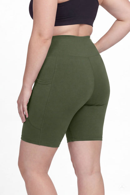 Plus size model wearing SweetLegs Cedar High-Waisted Pocket Biker Shorts in green showing back pocket detail