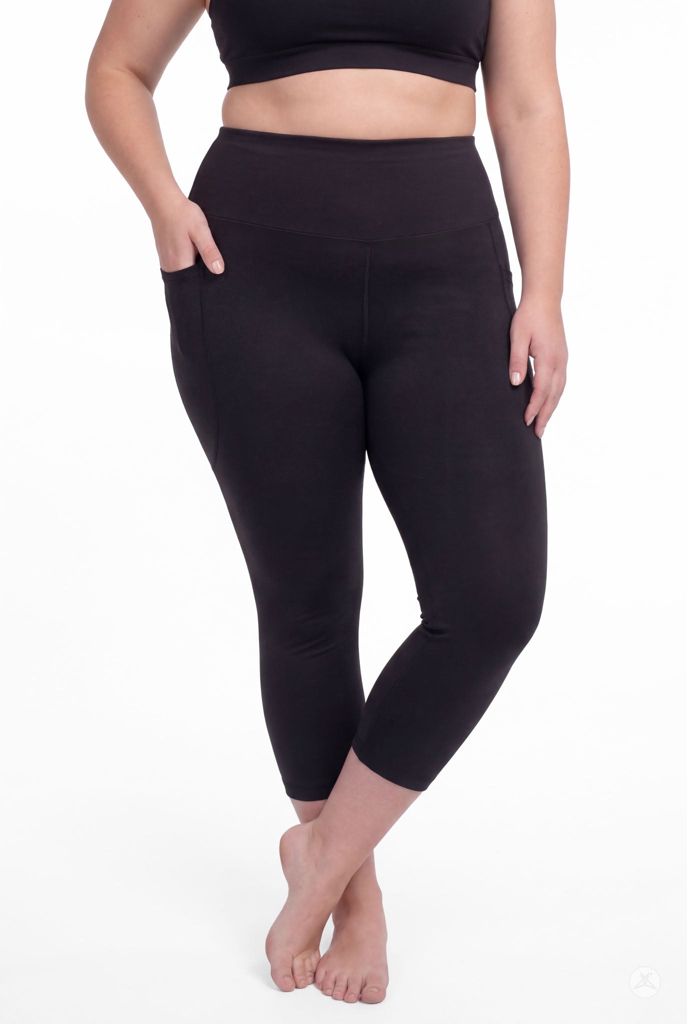 Woman wearing SweetLegs Black High-Waisted Pocket Crops standing barefoot with one hand in pocket and relaxed pose