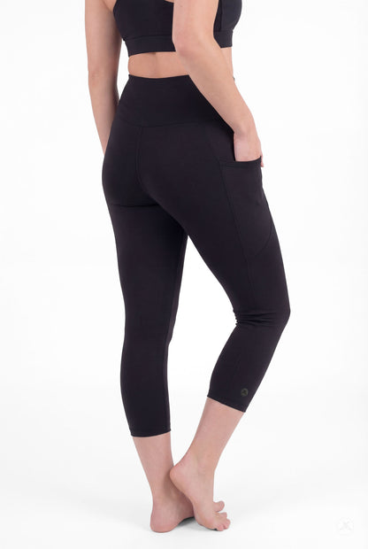 Woman barefoot wearing SweetLegs Black High-Waisted Pocket Crops with side pocket detail in relaxed back pose