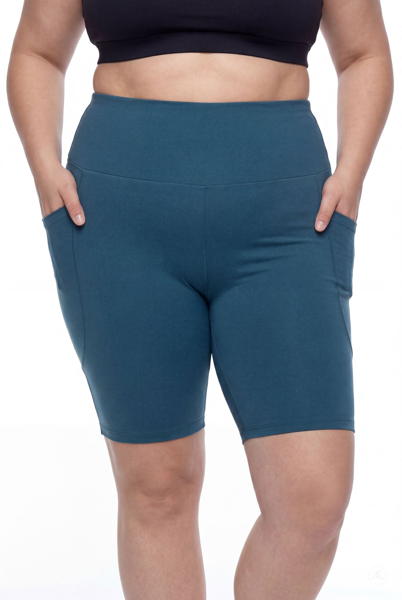 Plus size woman wearing SweetLegs Deep Teal High-Waisted Pocket Biker Shorts with hands in side pockets and elastic waistband