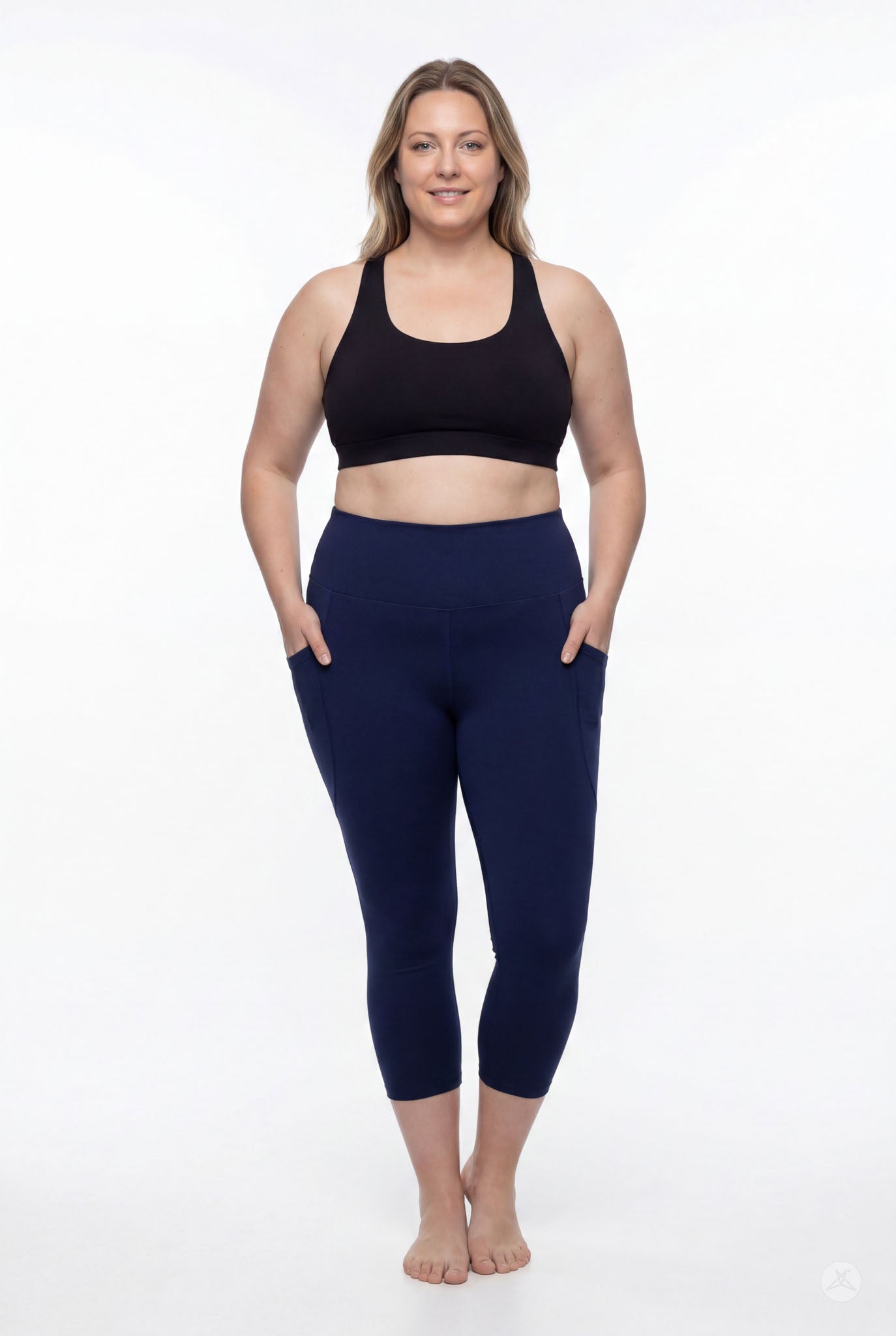 Plus size woman smiling wearing SweetLegs Still Water High-Waisted Pocket Crops with pockets and black sports bra