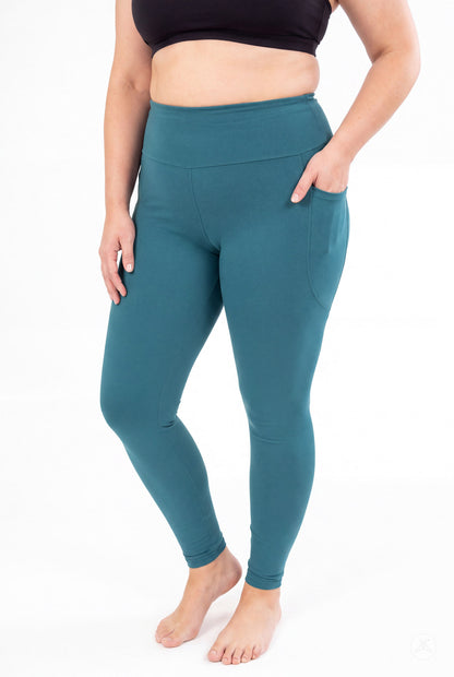 SweetLegs Deep Teal High-Waisted Pocket Leggings worn by a barefoot model with one hand in the side pocket