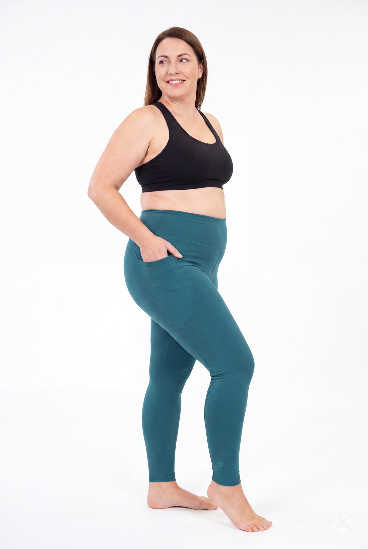 SweetLegs Deep Teal High-Waisted Pocket Leggings worn by a smiling model in a black sports bra