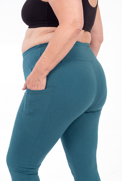 SweetLegs Deep Teal High-Waisted Pocket Leggings shown from behind with a hand in the side pocket