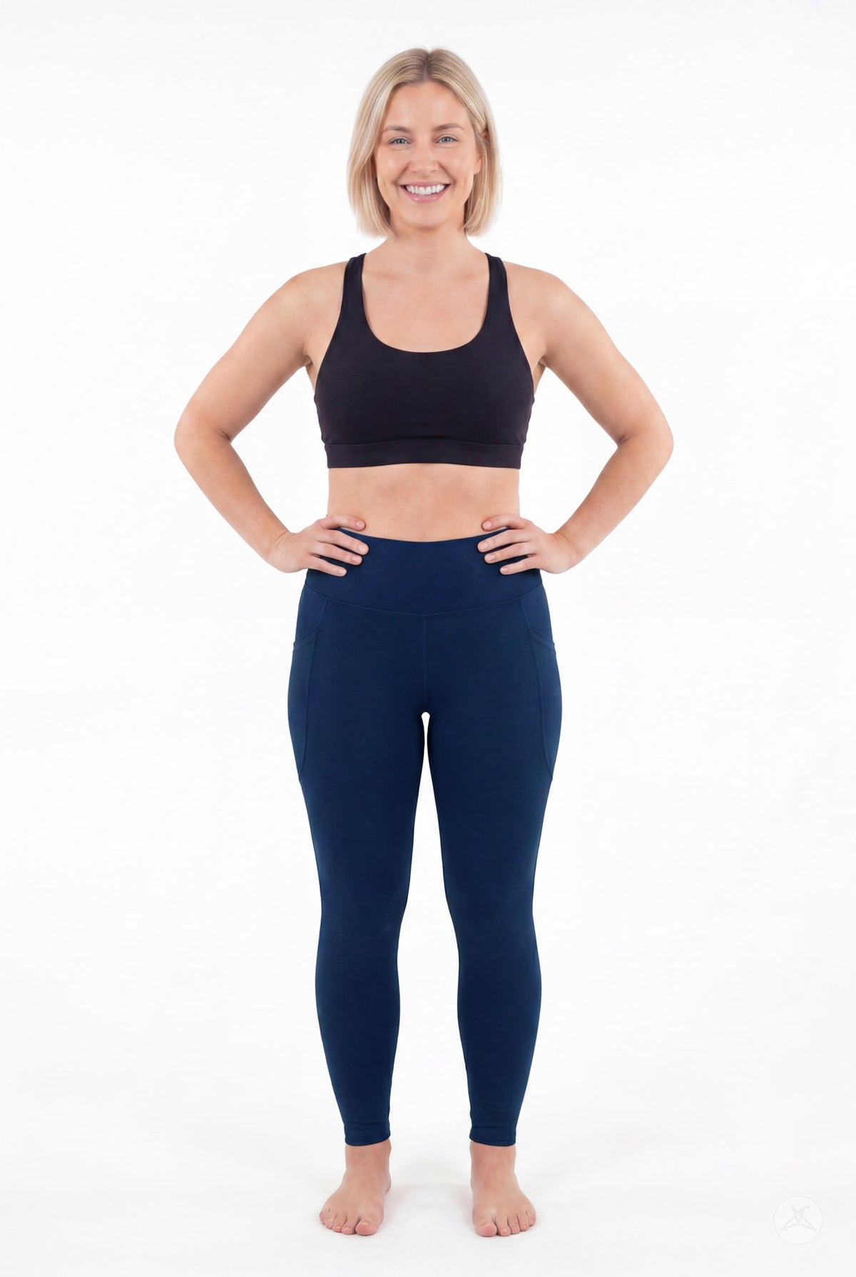 SweetLegs Still Water High-Waisted Pocket Leggings worn by a smiling model standing with hands on hips