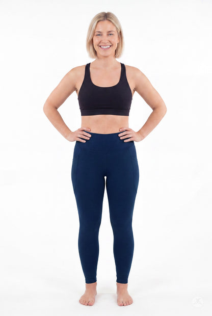 SweetLegs Still Water High-Waisted Pocket Leggings worn by a smiling model standing with hands on hips