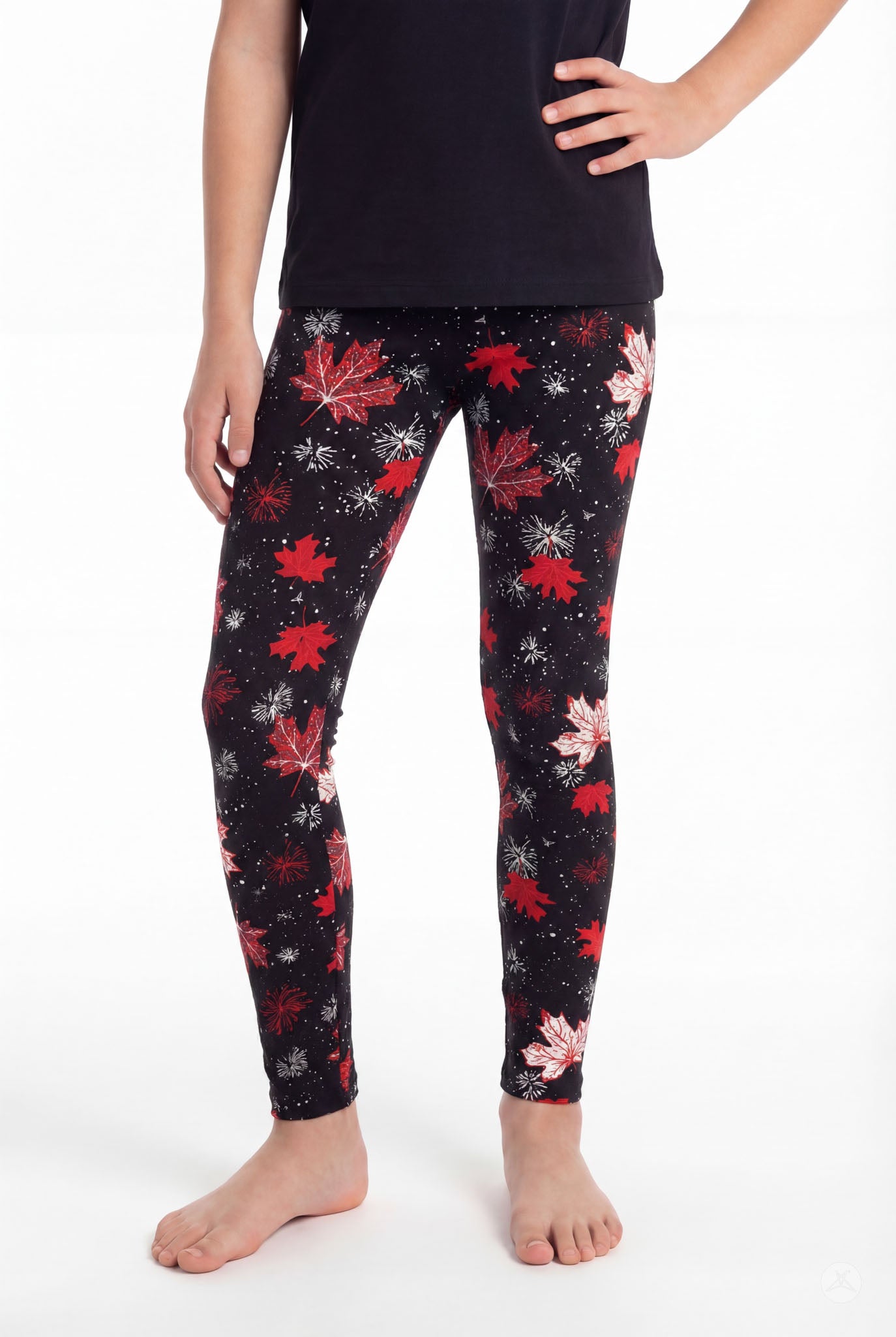 Child wearing SweetLegs Maple Mood Kids leggings with red maple leaf pattern on black background barefoot