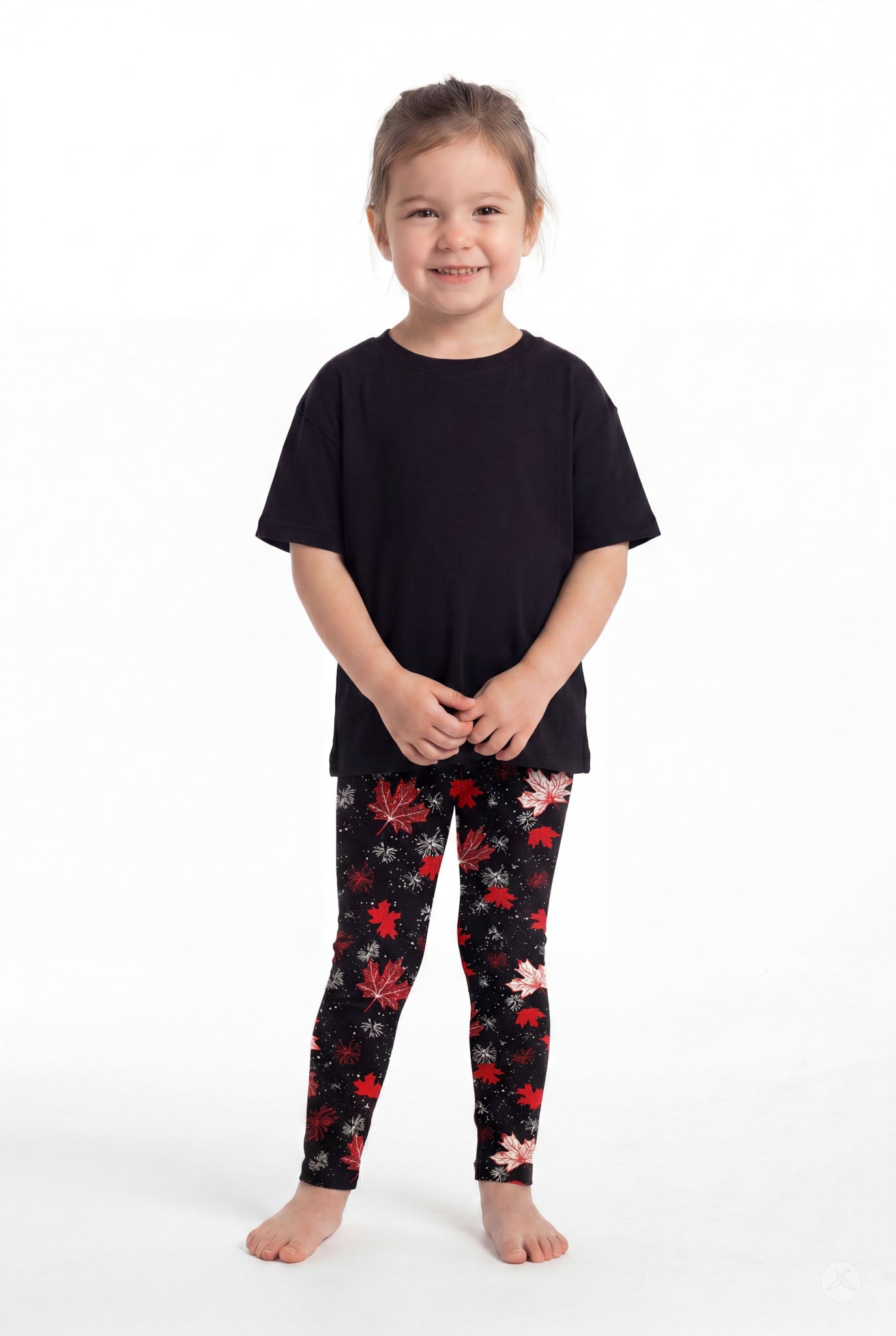 Child smiling wearing SweetLegs Maple Mood Kids leggings with red and white leaf pattern and black top