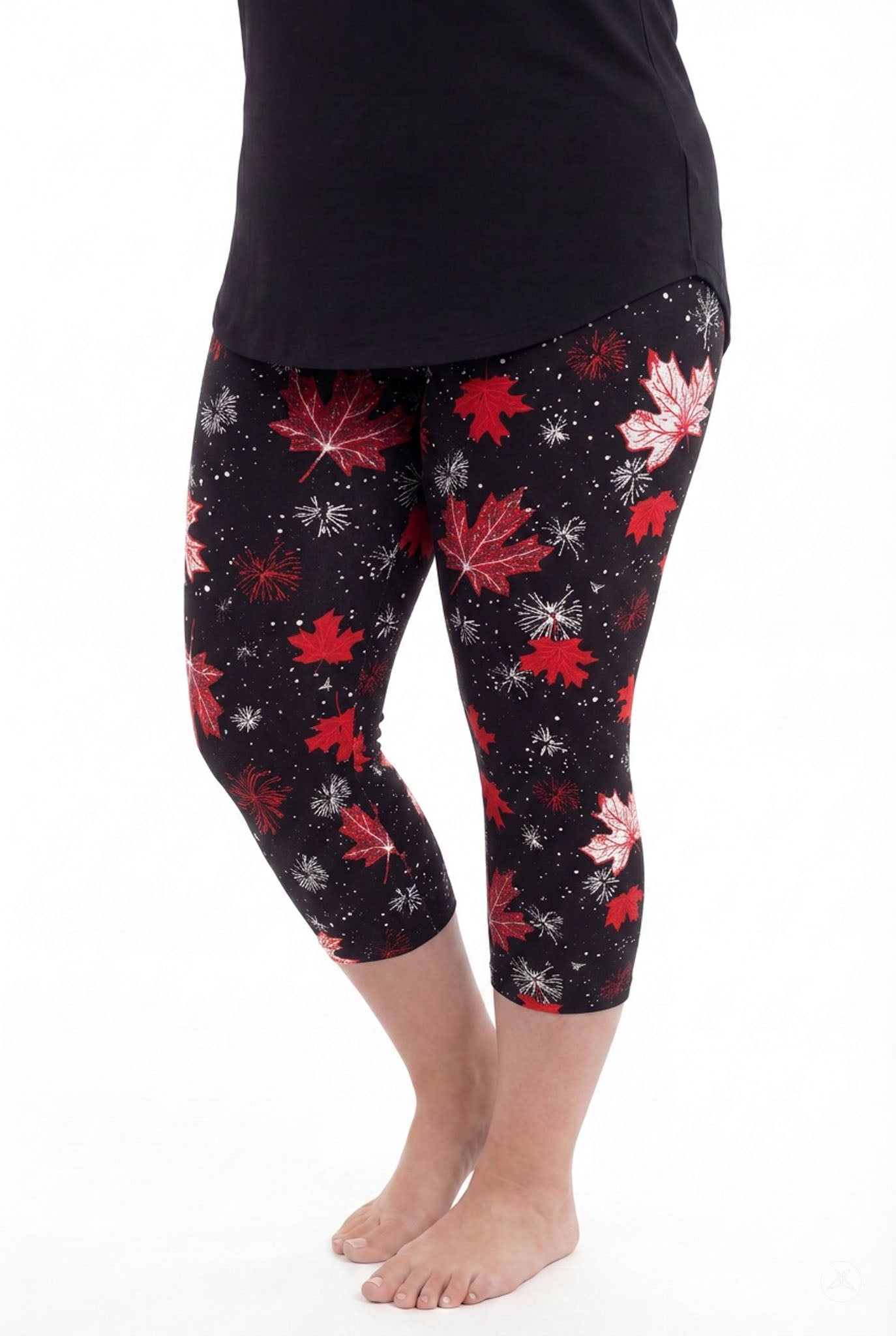 Woman wearing SweetLegs Maple Mood Crops with red and white maple leaf print and black top standing barefoot side view