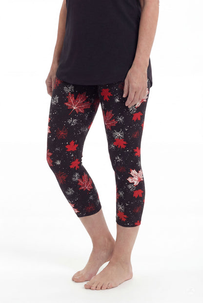 Woman wearing SweetLegs Maple Mood Crops with red and white maple leaf pattern and black top standing barefoot